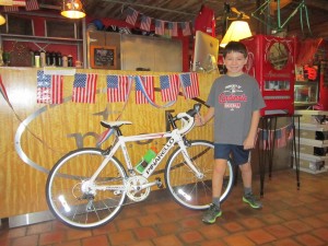 Ten year old Luka with his first road bike. A new Pinarello Speedy with 24 inch wheels! Looking Good!